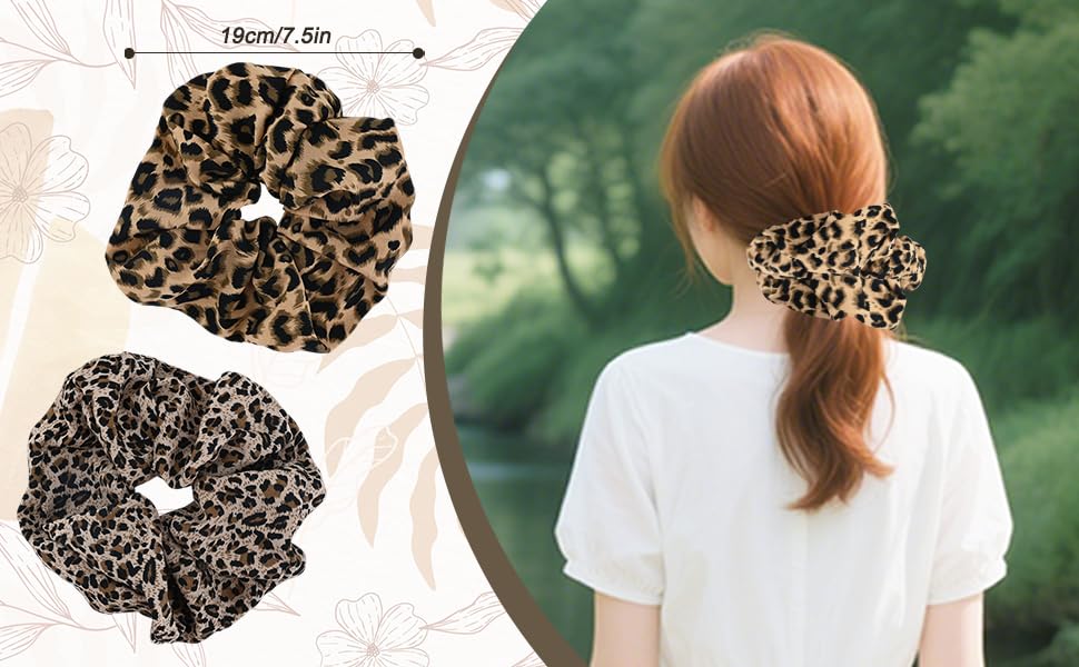 Leopard print hair scrunchies shown flat and worn. Elastic fabric bands with animal pattern in brown and black. Measurement of 19cm/7.5in indicated. Demonstrated on ponytail.