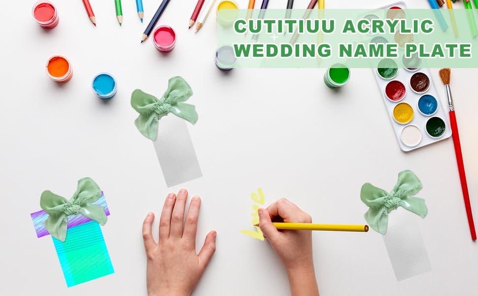 Text reads 'WEDDING NAME PLATE'. Colorful craft supplies including paint dots, brushes, and decorative elements arranged on white surface.
